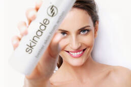 woman with skinade bottle